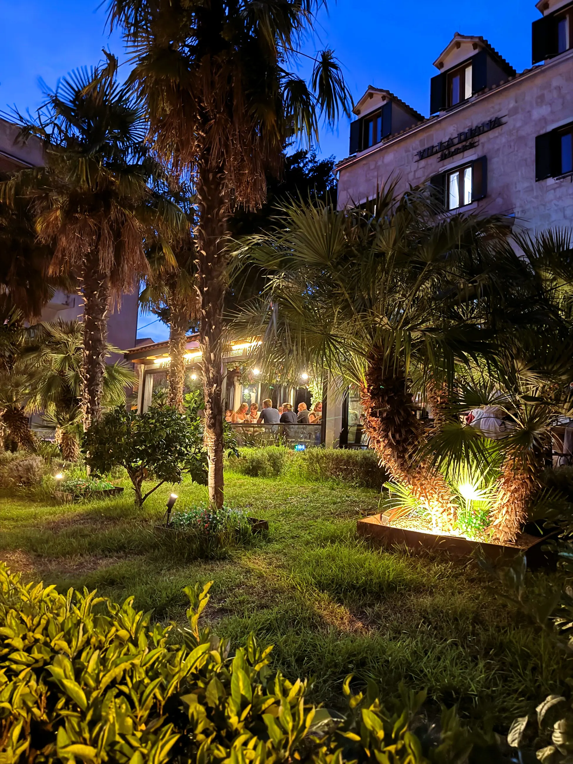 The lit palm garden in front of the pizzeria, in the evening, Pizzeria Villa Diana, Lučac, Split