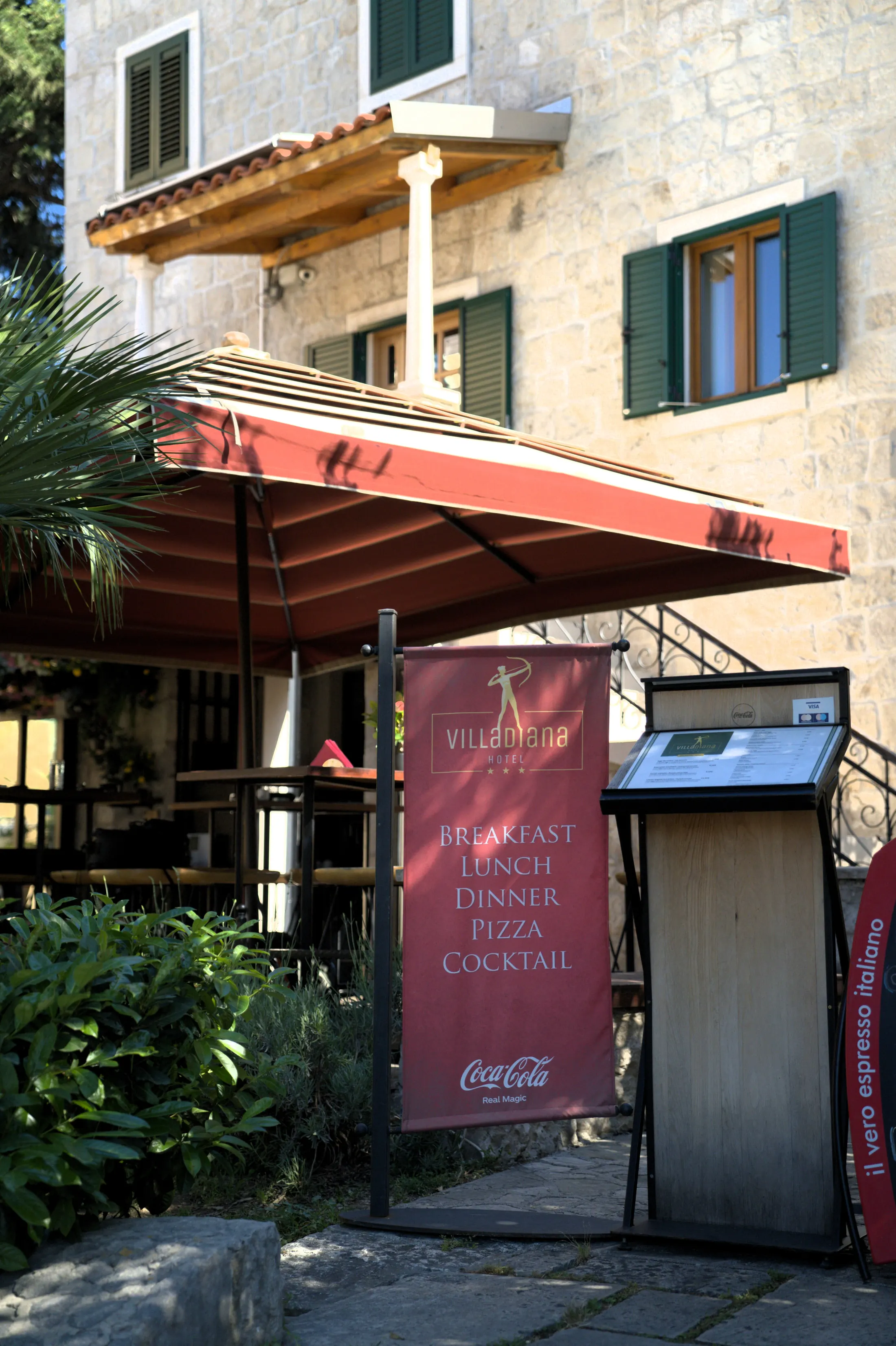 The pizzeria entrance with the menu stand and covered terrace, Pizzeria Villa Diana, Lučac, Split