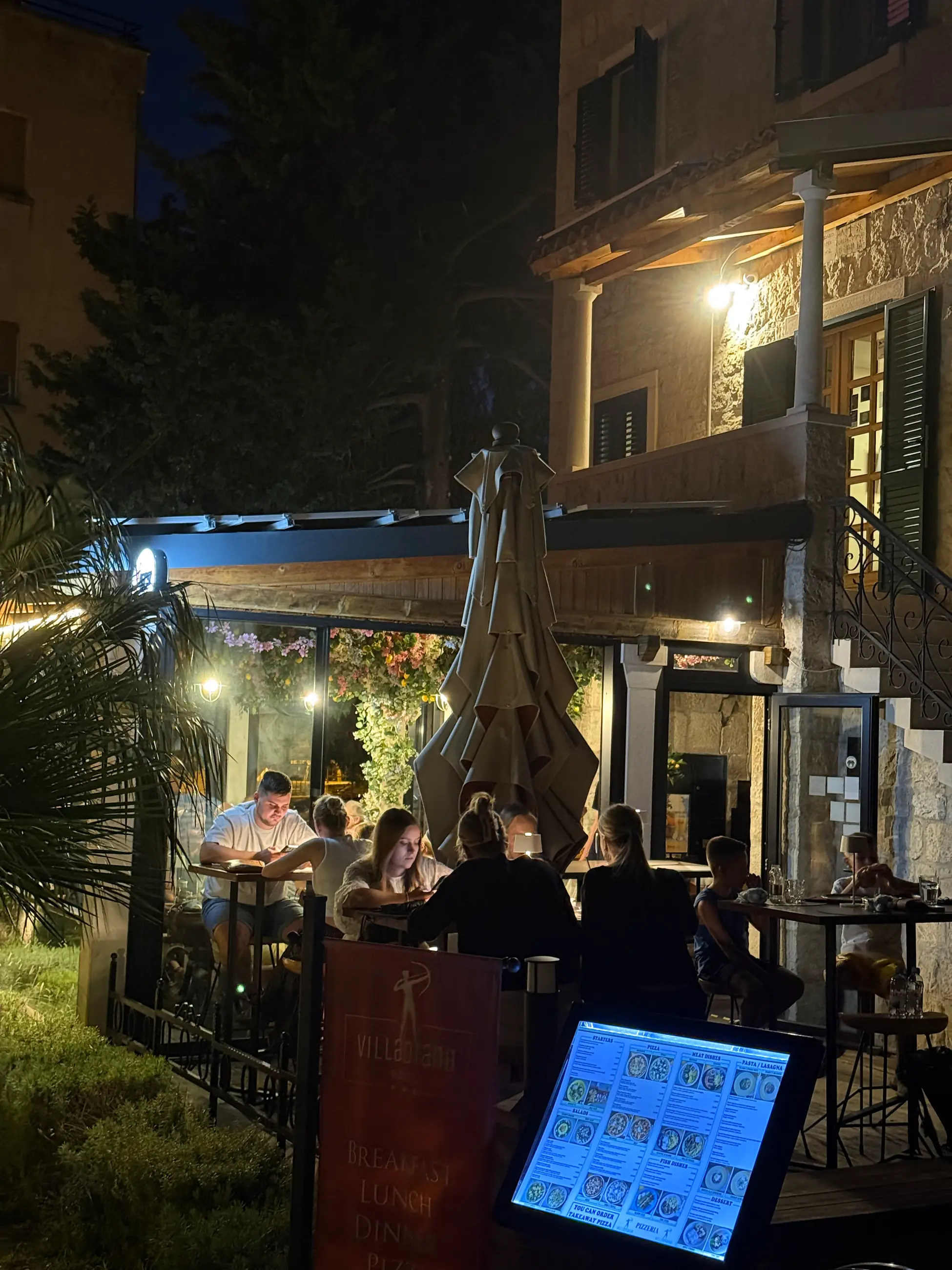 Tables in the garden under the lights, in the evening, Pizzeria Villa Diana, Lučac, Split