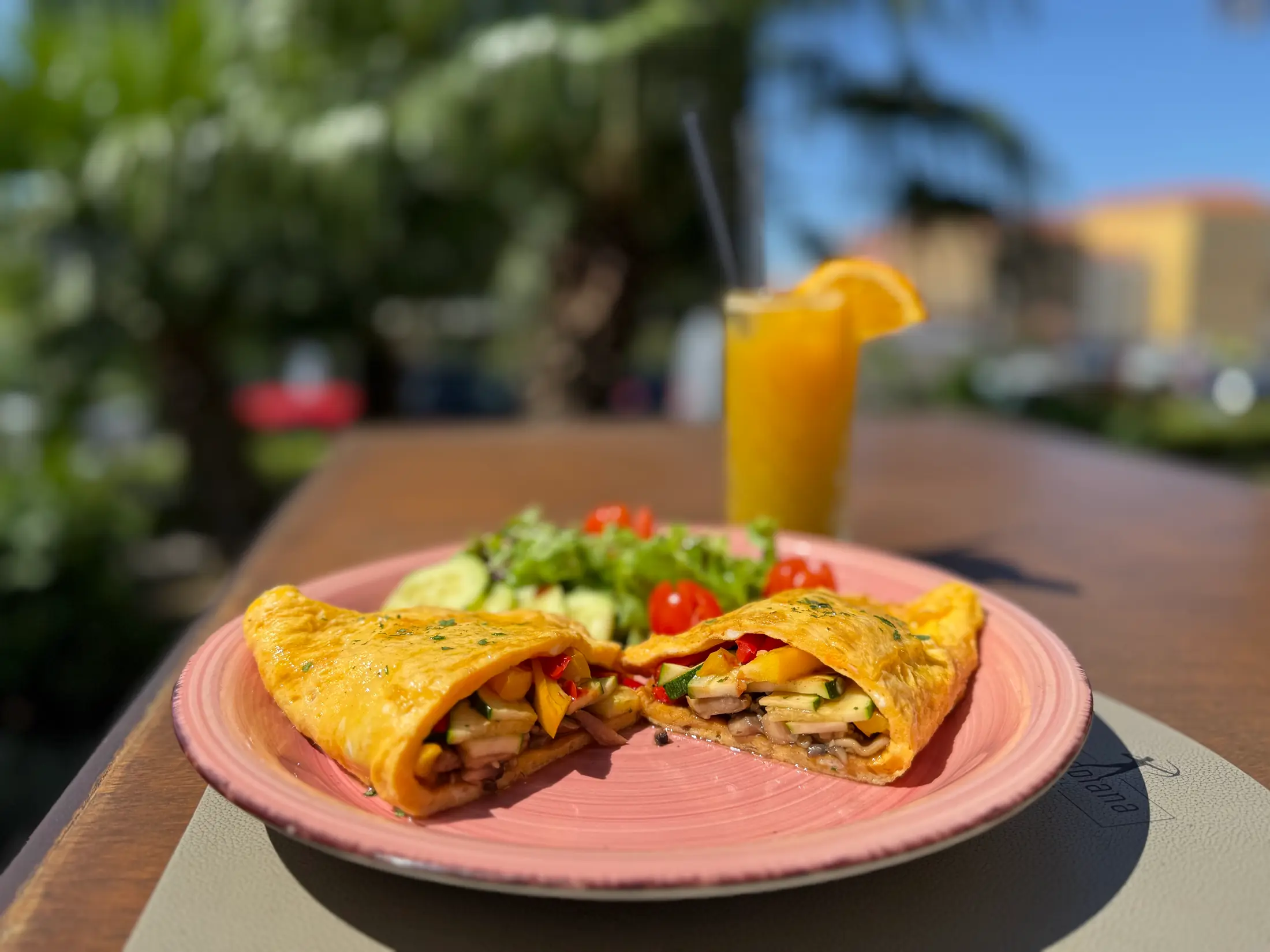 An omelette with salad and a juice on a terrace table, Pizzeria Villa Diana, Lučac, Split