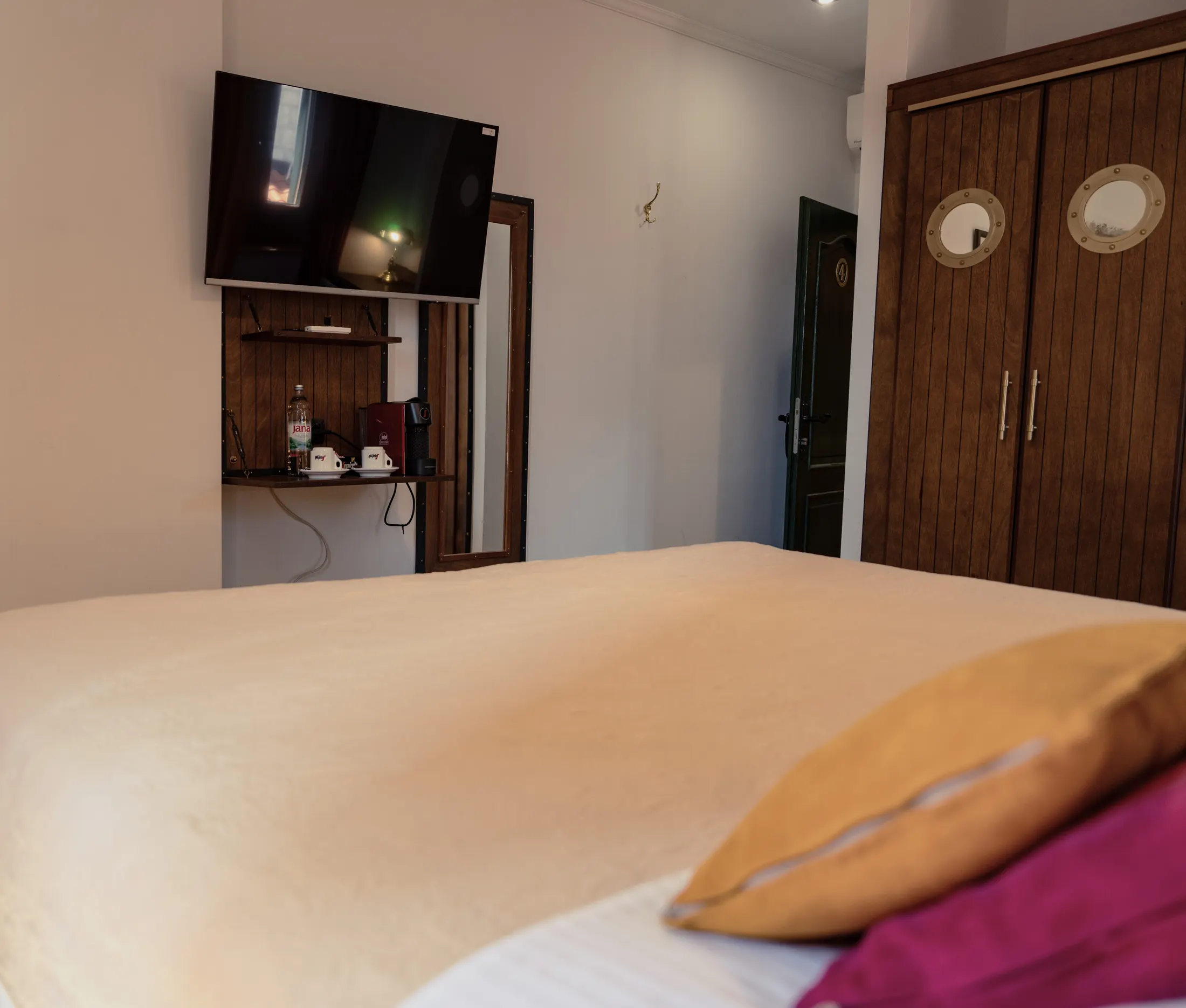 The television, coffee machine and wardrobe with porthole windows, Hotel Villa Diana, Lučac, Split