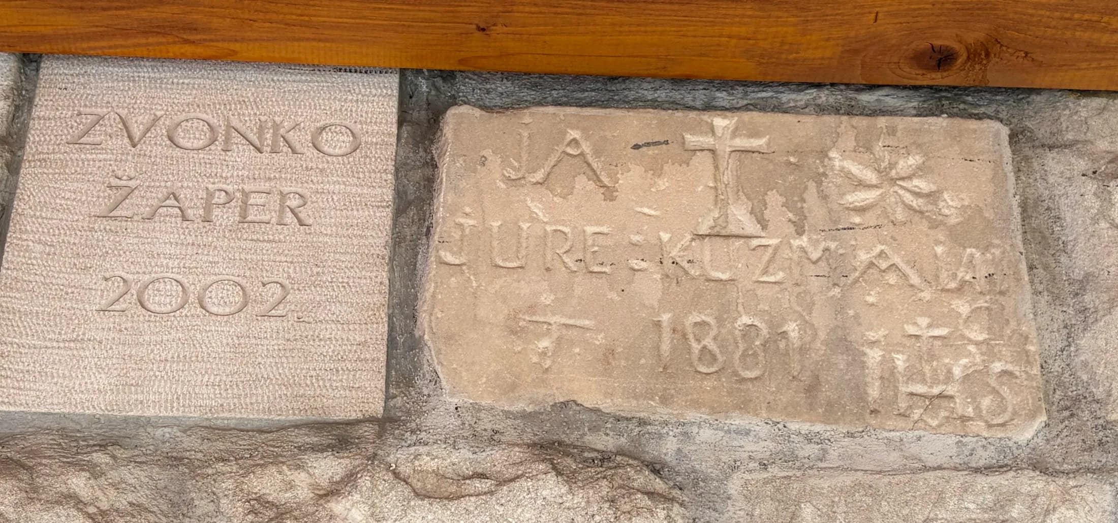 The stone set above the entrance, carved with a cross, the name Jure Kuzman and the year 1881, Hotel Villa Diana, Lučac, Split