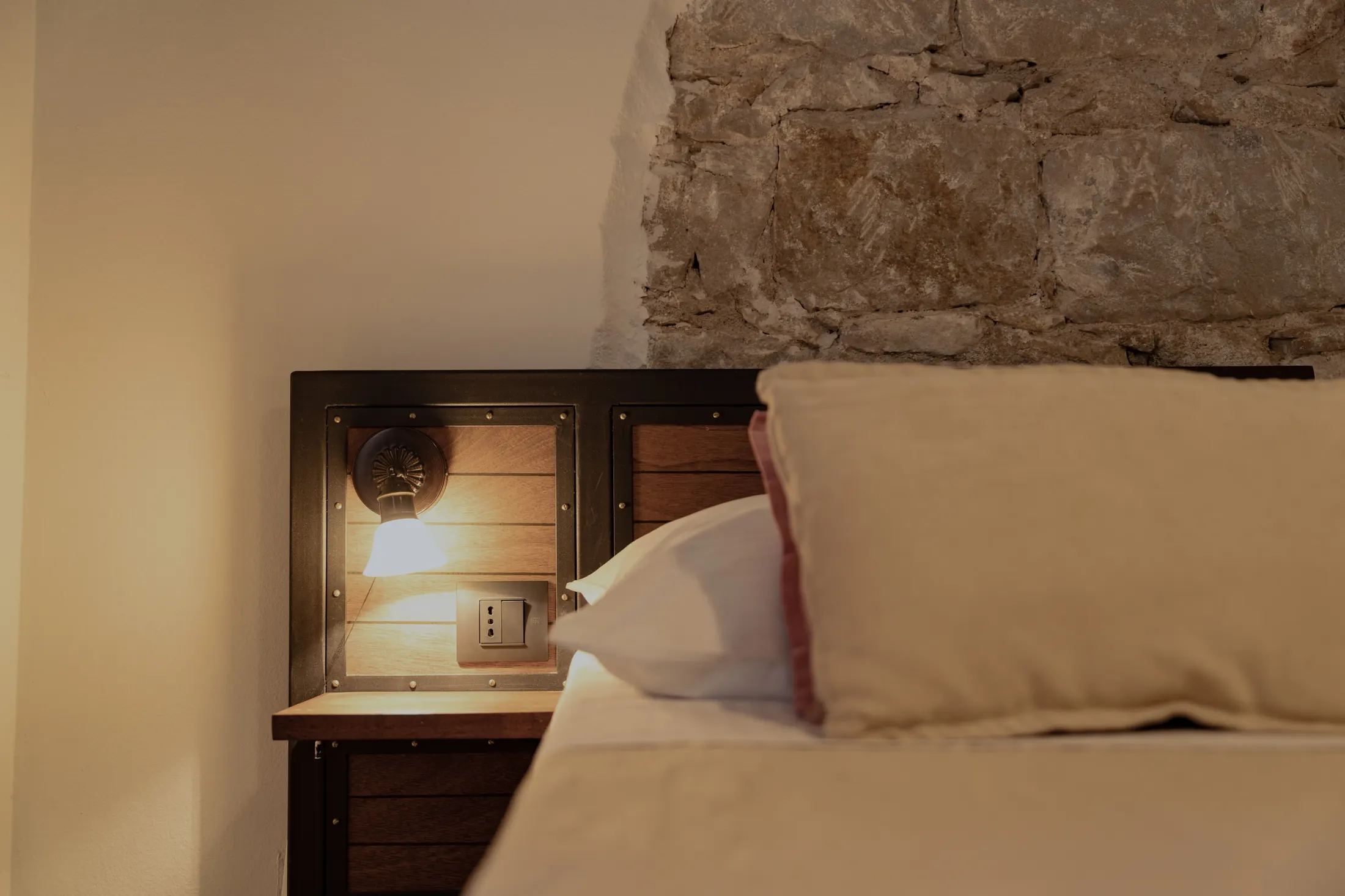 The bedside table with a lamp and socket at the headboard, Hotel Villa Diana, Lučac, Split